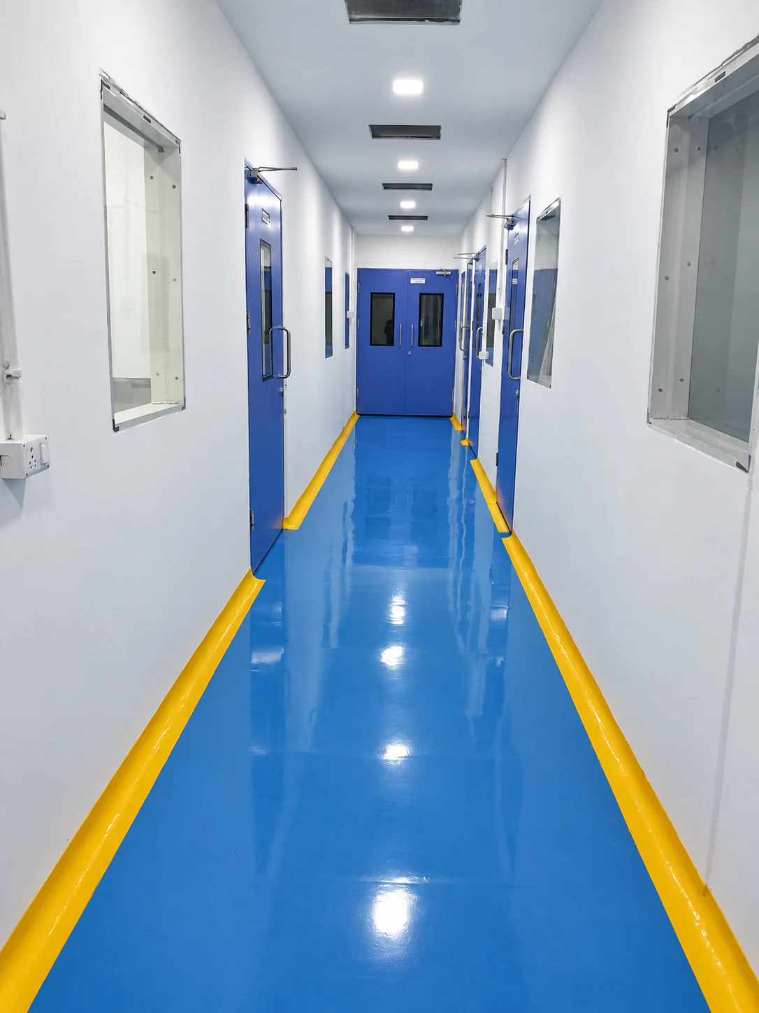 Clean Healthy Health production corridor with blue flooring and marked yellow edges