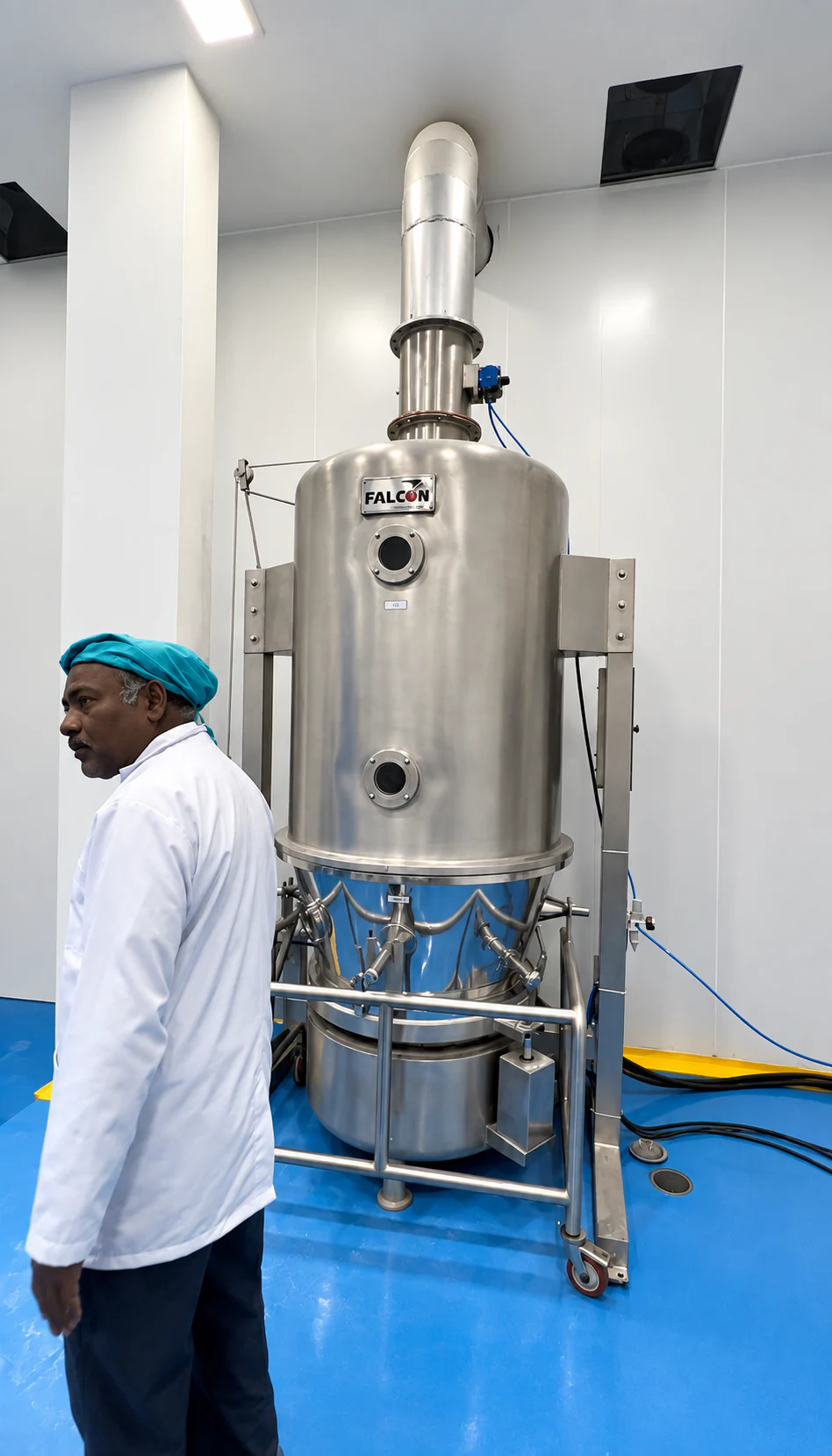 Healthy Health team member standing beside tall stainless-steel processing equipment