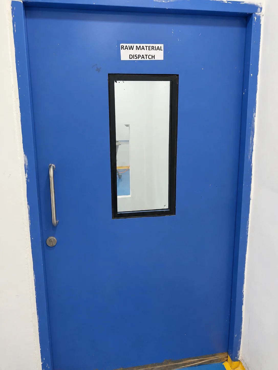 Blue raw material dispatch door inside the Healthy Health facility